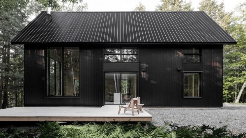 O casă neagră din metal se ascunde într-o pădure din Quebec - O casă neagră din