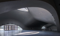Un muzeu subteran cu acoperiș vălurit din beton Deep Time Palace este cea mai mare clădire